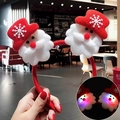 Detail of LED Christmas headband with plush Santa Claus figures and glowing snowflake pattern - LED Snowflake Santa