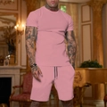 Close-up of men's pink summer leisure tracksuit set featuring a t-shirt and athletic shorts - Pink
