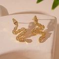 Macro shot of gold snake earrings with sparkling cubic zirconia on a stone surface - Snake Shape (WE1424) / Gold