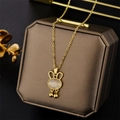 Golden cat eye opal rabbit pendant necklace with bells on a brown jewelry box - 8947 Golden Rabbit