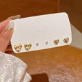 Three-pair gold bow, pearl, and heart zircon stud earring set on display card - Gold Bowknot Pearl Style (E6490)