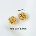 Macro detail of 8.8mm gold-plated beads with geometric patterns and red zircon insets - Style 09 Square Red Gem-Aperture 1.8mm