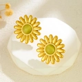 Golden sunflower earrings with translucent green stone center on a white pedestal - Simulation Sunflower Green Gem