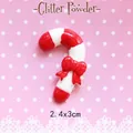 Close-up of a 2.4x3cm Christmas resin candy cane with a red bow for DIY crafts - Red and White Candy Cane