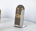 Golden long dangle earrings with hollow geometric spheres on arched mirror display stand - Square Base High 13cm