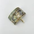 Detail of olive green and marble resin ponytail clip with gold metal frame finish - Green