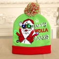 Green knitted Christmas hat with glowing LED Santa Claus pattern and colorful lights - Finger Santa Pattern