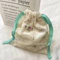 Detail of bear drawstring pouch with cute floral print and mint green cotton cord - Beige