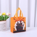 Orange non-woven Halloween gift bag featuring a haunted castle and witch silhouette - Halloween Orange