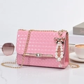 Pink woven crossbody bag with gold chain strap and pearl charm on marble desk - With Pendant / Small / Pink