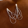 Detail of silver tassel earrings featuring multi-layered snake chain metal fringe - Silver