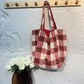 Classic red and white plaid wool tote bag hanging on a hook in a warm home setting - Red Plaid