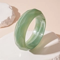 Macro view of wide green marble resin acrylic bangle on white stone pedestal - Green Faceted Bangle (88#)