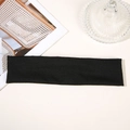 Flat lay of a black sweatband for running and yoga on a minimalist desk setup - Black