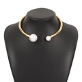 Macro detail of gold spiral choker necklace featuring asymmetrical white pearls on model - Gold