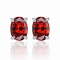 Macro shot of oval cut ruby red gemstone earrings in four-prong silver setting - 925 Silver / Garnet Red