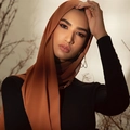 Solid terracotta pearl chiffon hijab scarf wrap for women shown on model with gold jewelry - Amber