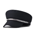 Detailed view of silver chain ornament on a black cotton baker boy cap with flat top - Black
