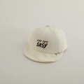 Detailed close-up of embroidery text on a soft cotton baby baseball cap in beige - 50cm 1-2 Years / White