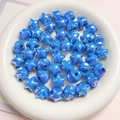 Iridescent blue star-shaped macaron beads displayed in a white dish for DIY jewelry - 16mm (Hole approx 2.5mm) / Sapphire Blue