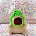 Plush capybara keychain with a green plush headgear on colorful foam bead background - Frog Hat Light Brown + Bead Chain