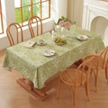 Close-up of green cotton linen tablecloth with white leaf pattern on a wooden table - 60*60cm / Green With White Leaf
