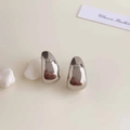 Polished silver irregular water drop earrings on a minimalist cream background display - Rhodium Plated Silver Polished Tear Drop