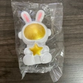 White rabbit astronaut toy with golden star detail in clear plastic packaging - Small Star Rabbit Gold Star