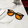 Chic black frame sunglasses with bright orange lenses and silver dot accents - Black Frame Yellow Lens