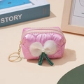 Close-up of pink quilted coin purse with mesh bow and gold keychain hardware - Pink