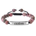 Detail of custom engraved metal bar on pink zebra stone beaded adjustable bracelet - Black Line Red Rhodonite