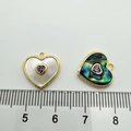 Detail view of 18K gold-plated heart charms with natural shell inlay and purple gem - Heart Purple Zirconia (White Shell)