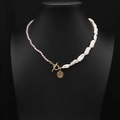 Pink crystal and pearl necklace with golden coin pendant on a black bust display - Pink Quartz Baroque Pearl Coin Necklace