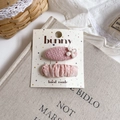 Close-up of pink fabric floral hair clips set on a bunny card for girls hair styling - Pearl Flower