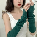 Detail of dark green knitted arm sleeves featuring classic vertical ribbed texture - Green