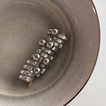Artistic silver spiral hair tie with polished metal beads in a ceramic bowl - Gray Spiral Pearl Style / Gray Pearl Hair Braider