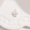 Macro shot of silver seashell pendant with tiny white zircon stones and hook detail - Silver Shell Pendant
