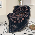 Detail of bohemian black woven blanket featuring moon phases and floral patterns - 130x160cm / Black Moon Phases