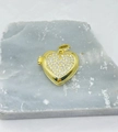 Detail of a golden heart locket pendant with crystal pavé on a textured stone surface - Full Pave Heart