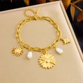 Detail shot of gold-plated stainless steel chain with sun, star and pearl charms - Sunflower and Starburst Pendant Style (B1649)