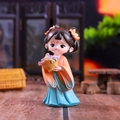 Detail of a Chinese style girl figurine in blue and orange hanfu holding purple flowers - Xi Shi (Tang Style)