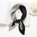 Detail of pleated silk scarf with black and grey color block design on a magazine - Black Light Grey Color Block