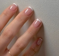 Close-up of pink French press-on nails with white tips in short square oval shape - Yellow Jelly Glue + Nail File Set