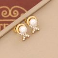 Macro view of C-shaped golden pearl earrings featuring crystal pavé accents - Rhinestone Cross Pearl Style (5#)