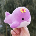 Close-up of a cute purple plush whale keychain with a yellow flower decoration - 10cm / Purple