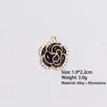 Detail view of a 1.9x2.2cm black enamel camellia pendant with white rhinestones - Style 11 Camellia B / Gold Frame