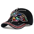 Distressed black baseball cap featuring a large colorful rhinestone butterfly and jeweled brim - Black