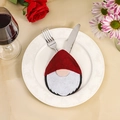 Christmas gnome cutlery pocket in red felt on a white ceramic plate for table decor - Red Gnome Style