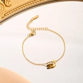 Polished gold stainless steel bracelet with letter D charm and crystal-set ring on mirror - Letter D Rhinestone Bracelet (7925) / Gold