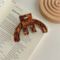 Close-up of tortoise shell pattern acetate claw clip on a vintage recipe book - Flower Brown